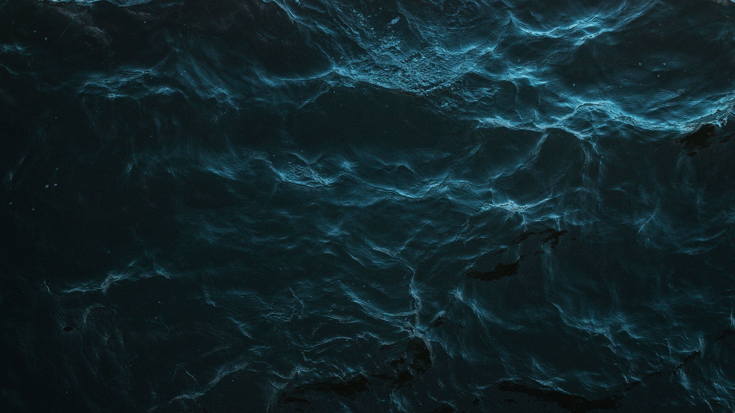 Dark ocean surface at night, seen from above